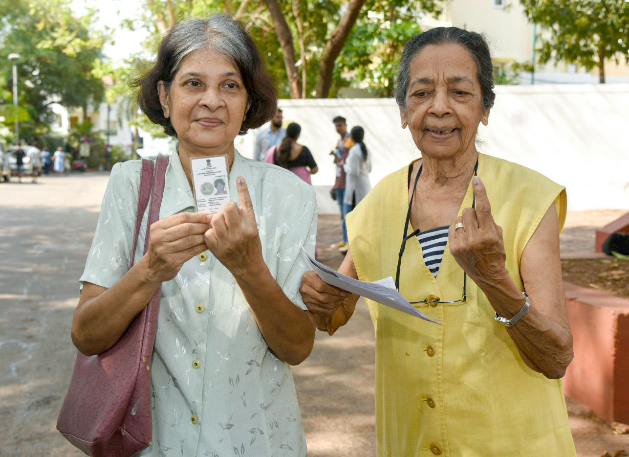 Voters showing mark of indelible ink after casting their votes, at a polling booth, during the 3rd Phase of General Elections-2024 at Government Primary and High School, Dona Paula, in Goa 