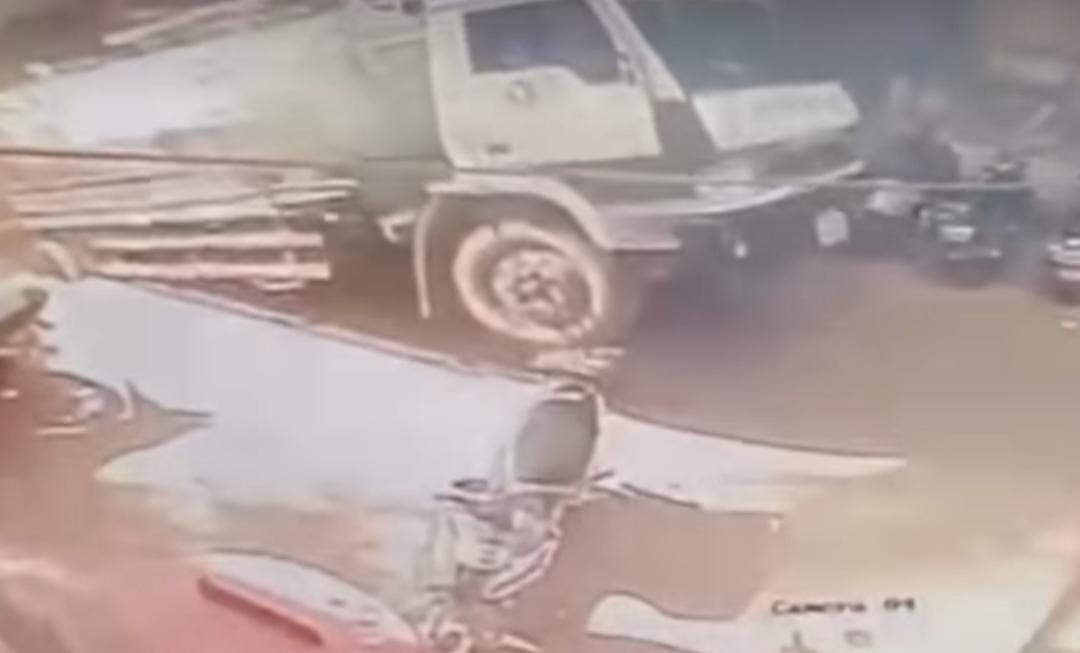 Truck falls into manhole in